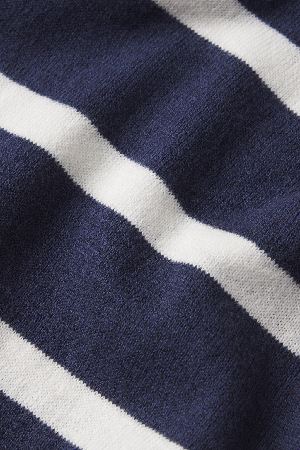 Close-up of the Evaline Sweater in Deep Navy Wharf Stripe, featuring horizontal white stripes on a soft, textured fabric with gentle folds.