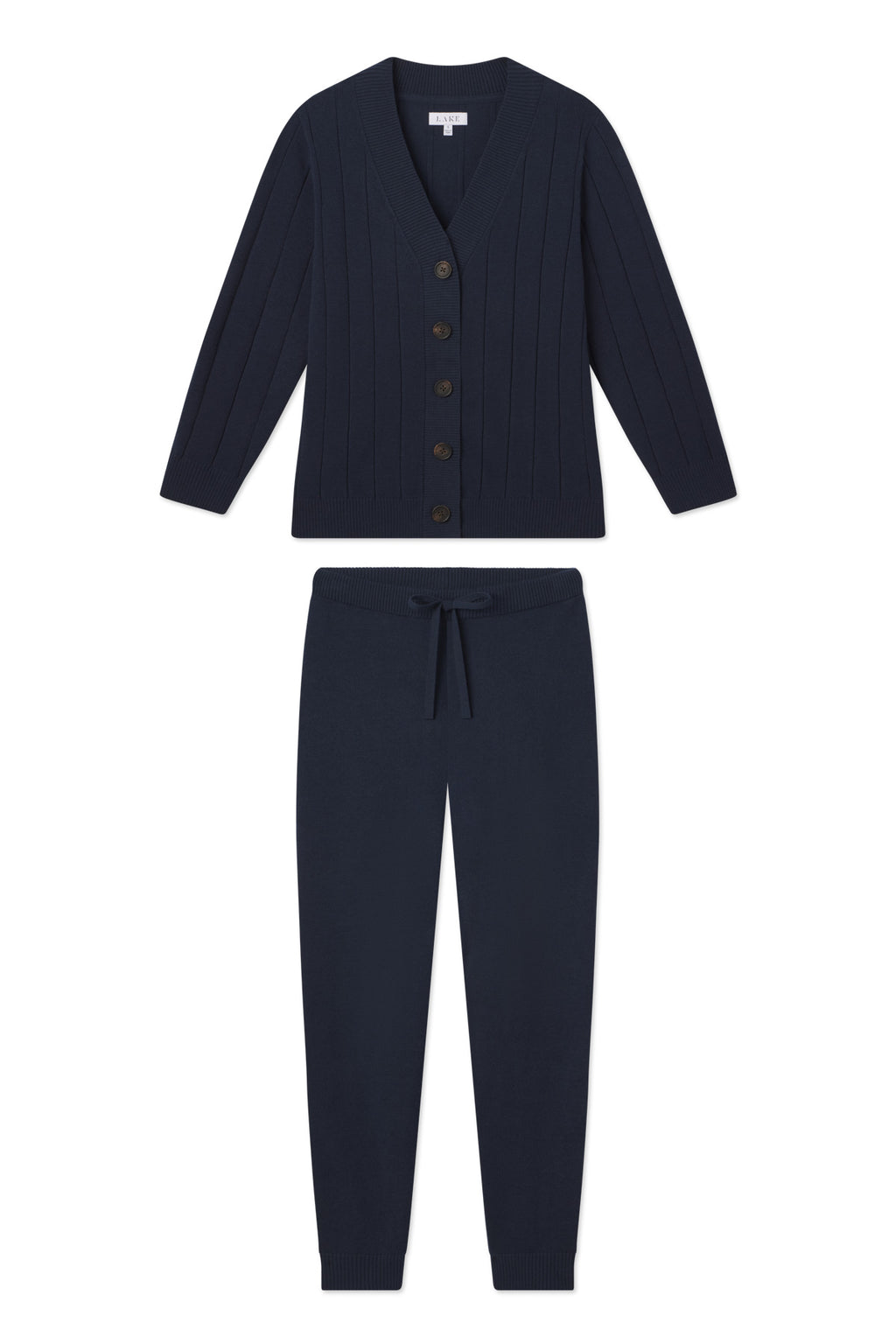 The Vesper Jogger Set in Deep Navy is a matching knit lounge set with a button-up, long sleeve ribbed cardigan and drawstring jogger pants—ideal for relaxing at home.