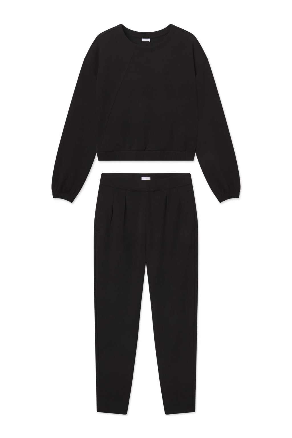 Black cropped sweatshirt and tapered pants set with pleated front detail and elastic waistbands.