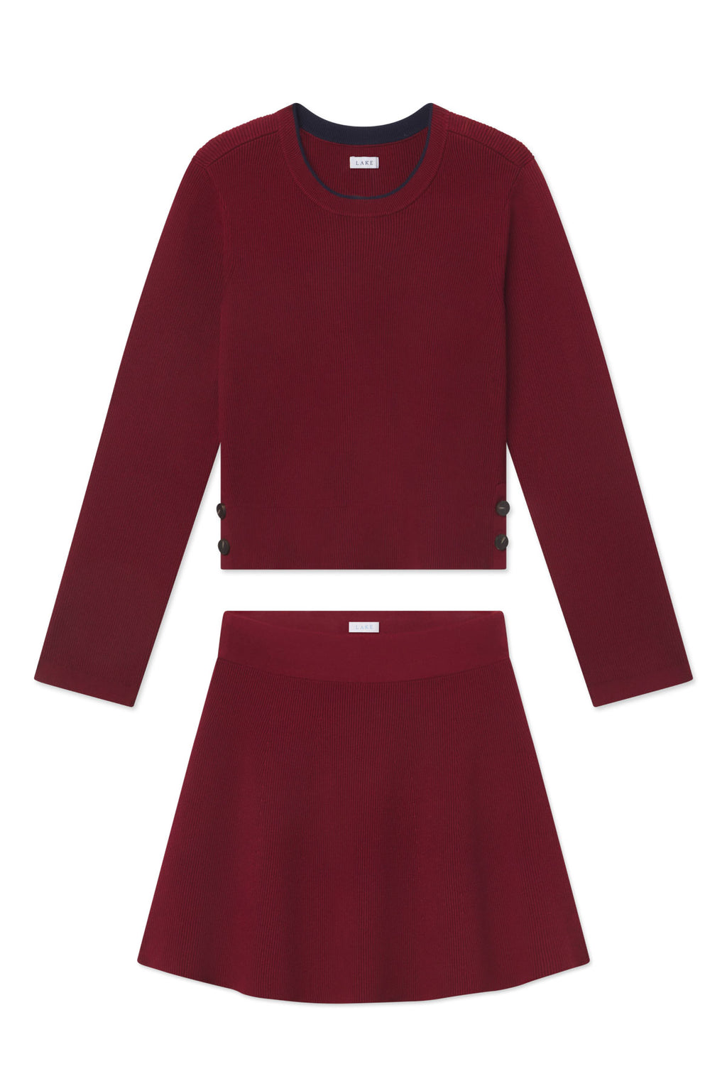 Burgundy ribbed two-piece set with long-sleeve crop top and A-line skirt with side buttons.