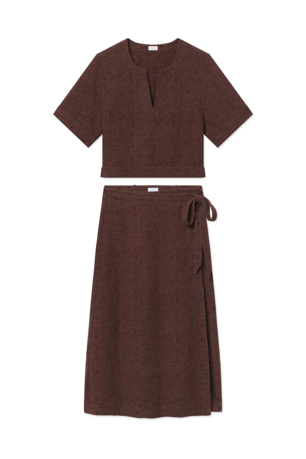 Brown jacquard two-piece set with short-sleeve popover top and wrap skirt with tie closure.