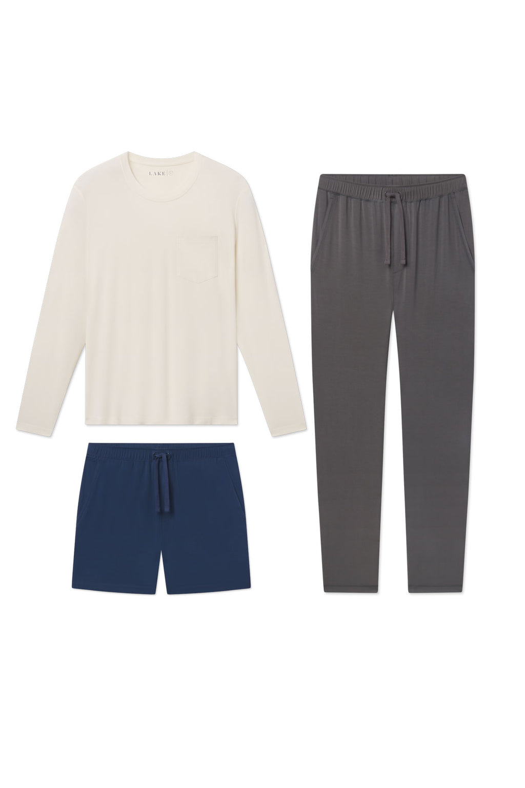 Cream long-sleeve shirt, navy shorts, and gray joggers displayed flat on white background.