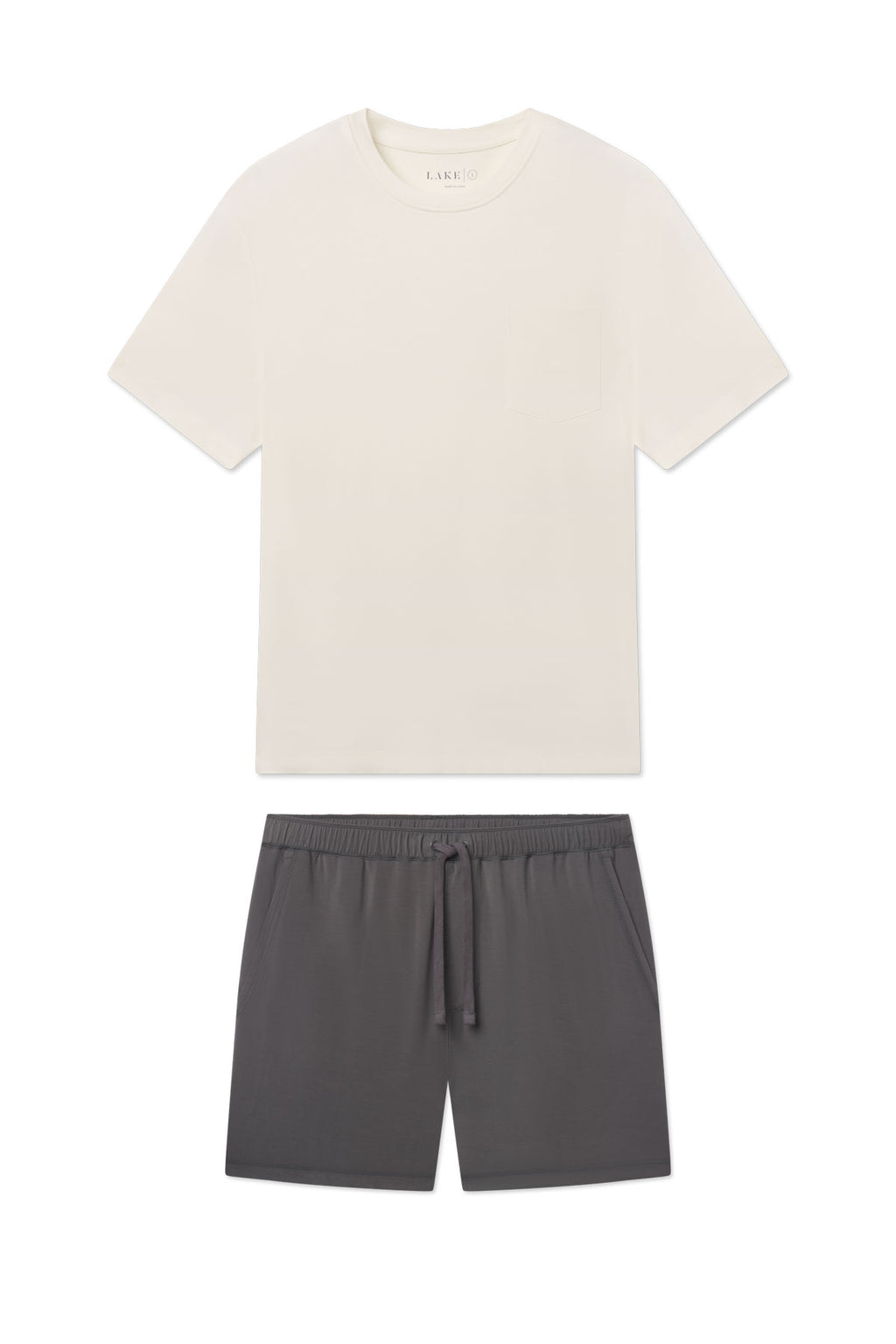 Cream t-shirt with crew neck and short sleeves paired with gray shorts featuring a drawstring waist.