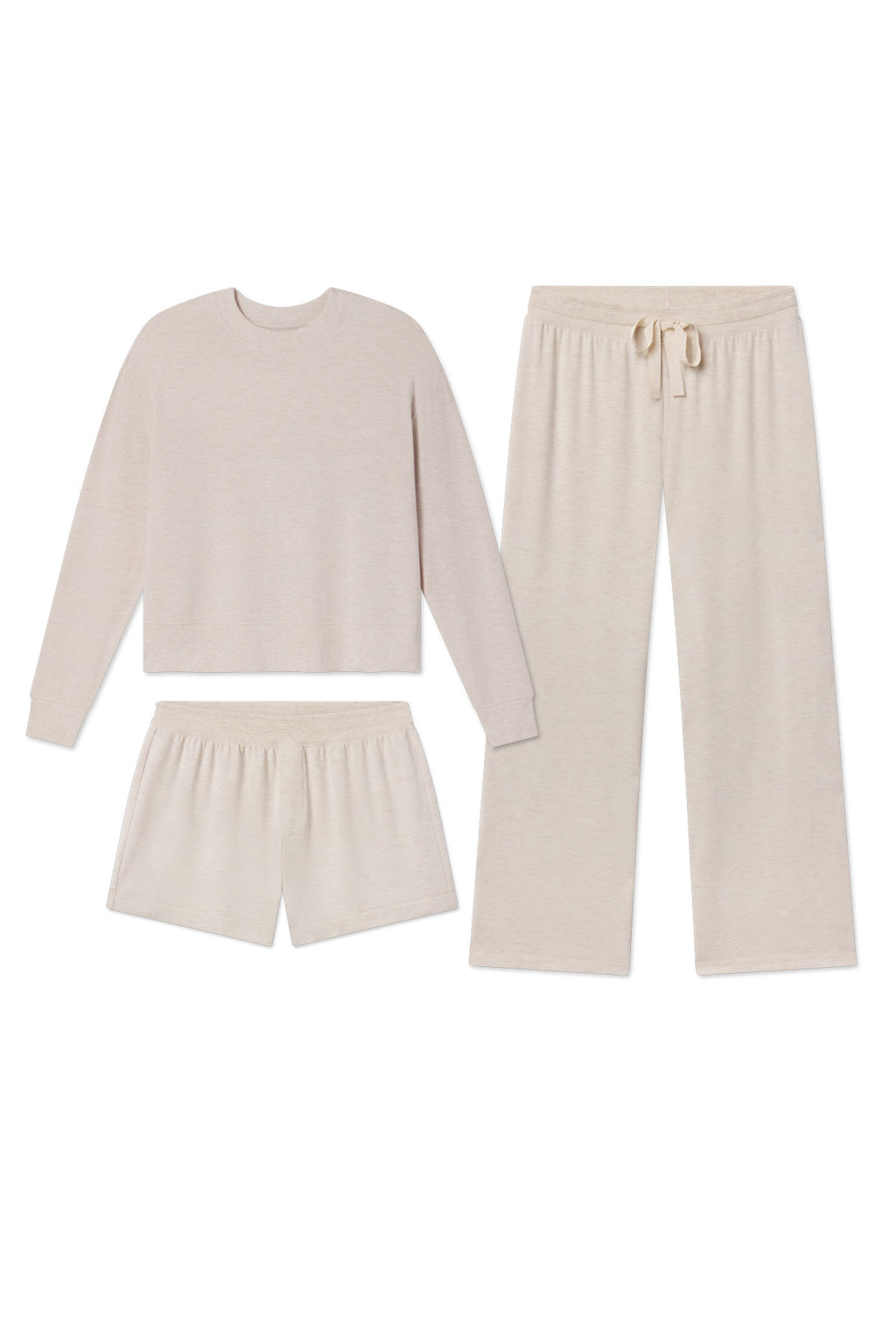 Three-piece lounge set in oat heather consisting of long-sleeve crewneck sweatshirt, shorts, and pants.