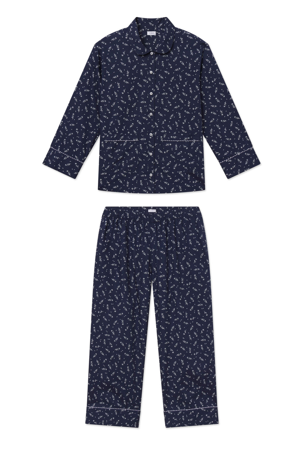 Navy long-sleeve pajama set with small floral print throughout and piped trim detailing on cuffs and pants hem.