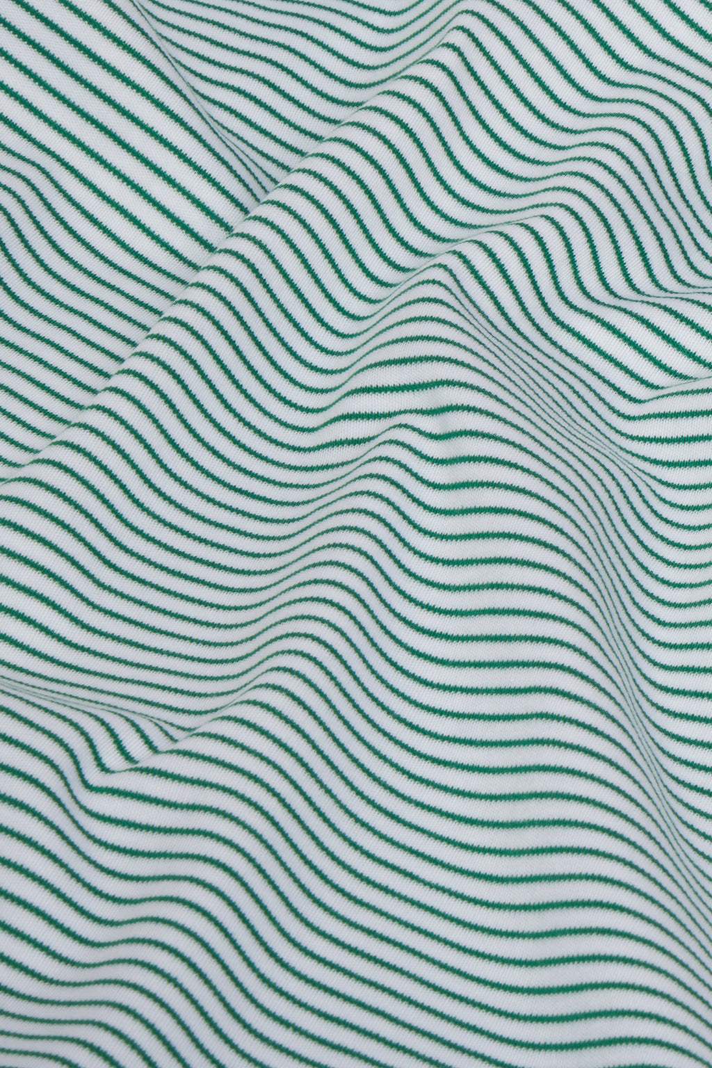 Close-up of the Pima Robe in Classic Green, featuring soft, textured fabric with thin dark green stripes forming an undulating pattern on a green and white background.