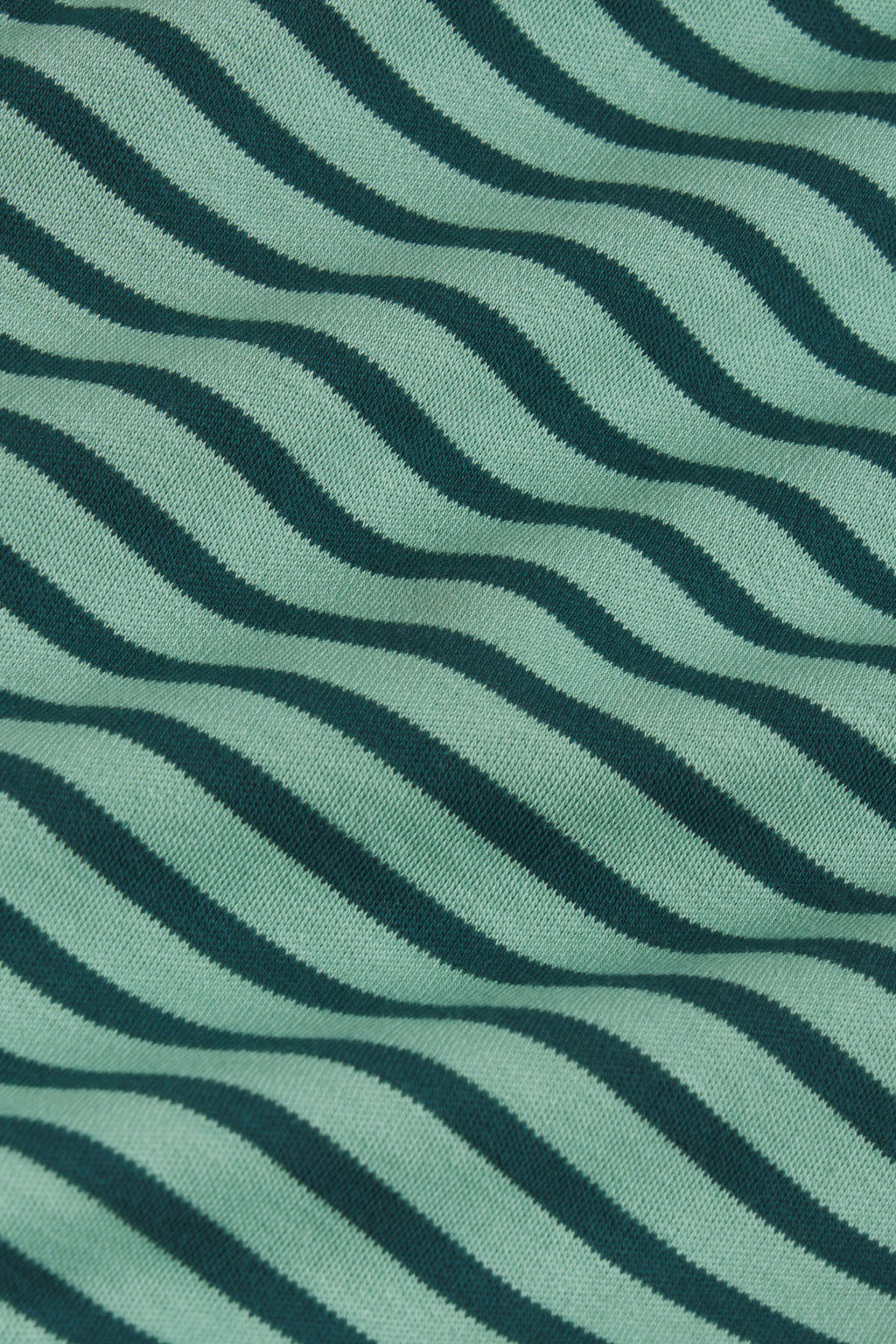 Light blue and dark teal fabric with diagonal wavy striped pattern.
