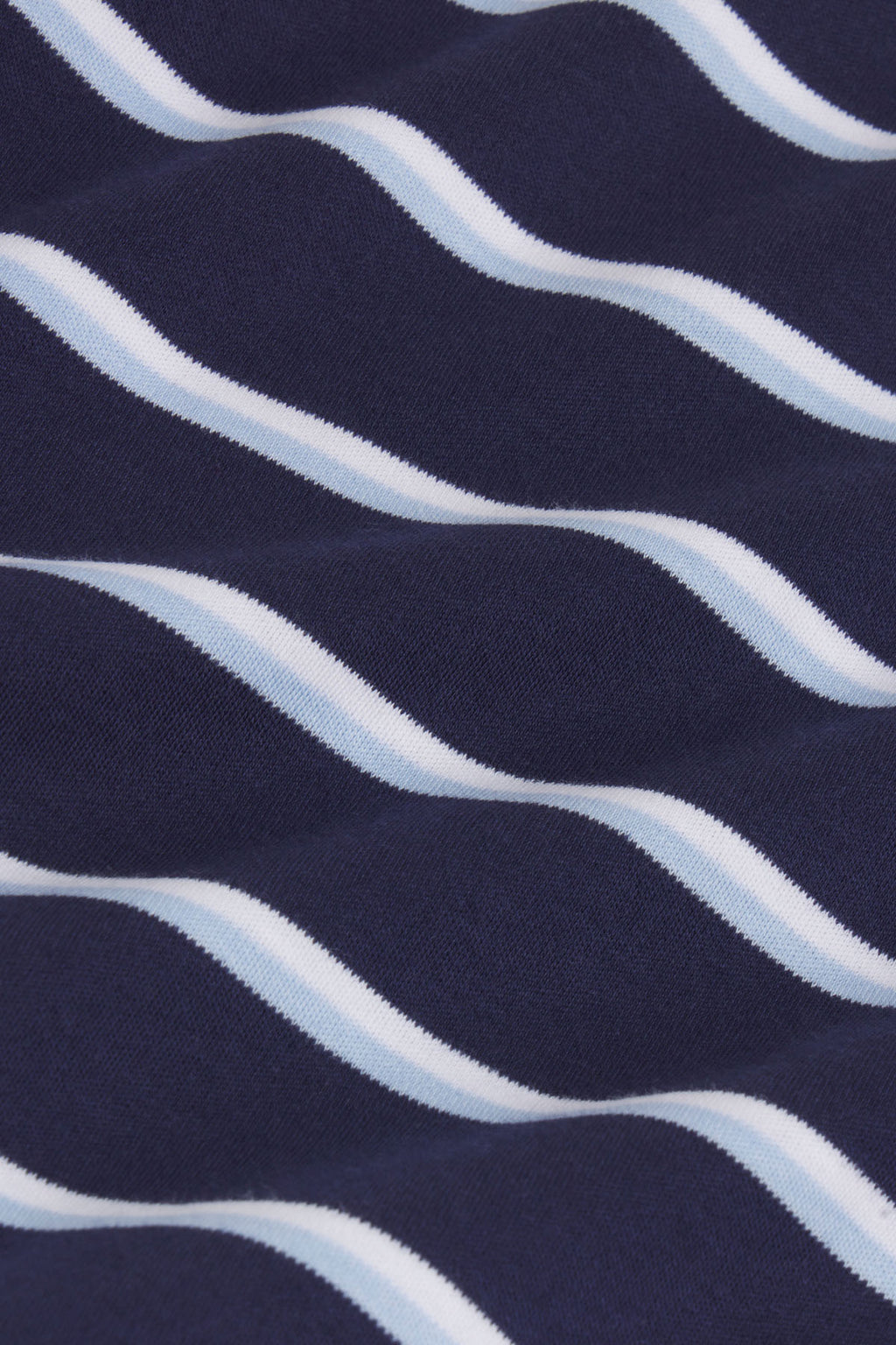 Navy and light blue wavy striped pajama fabric in textured knit material.