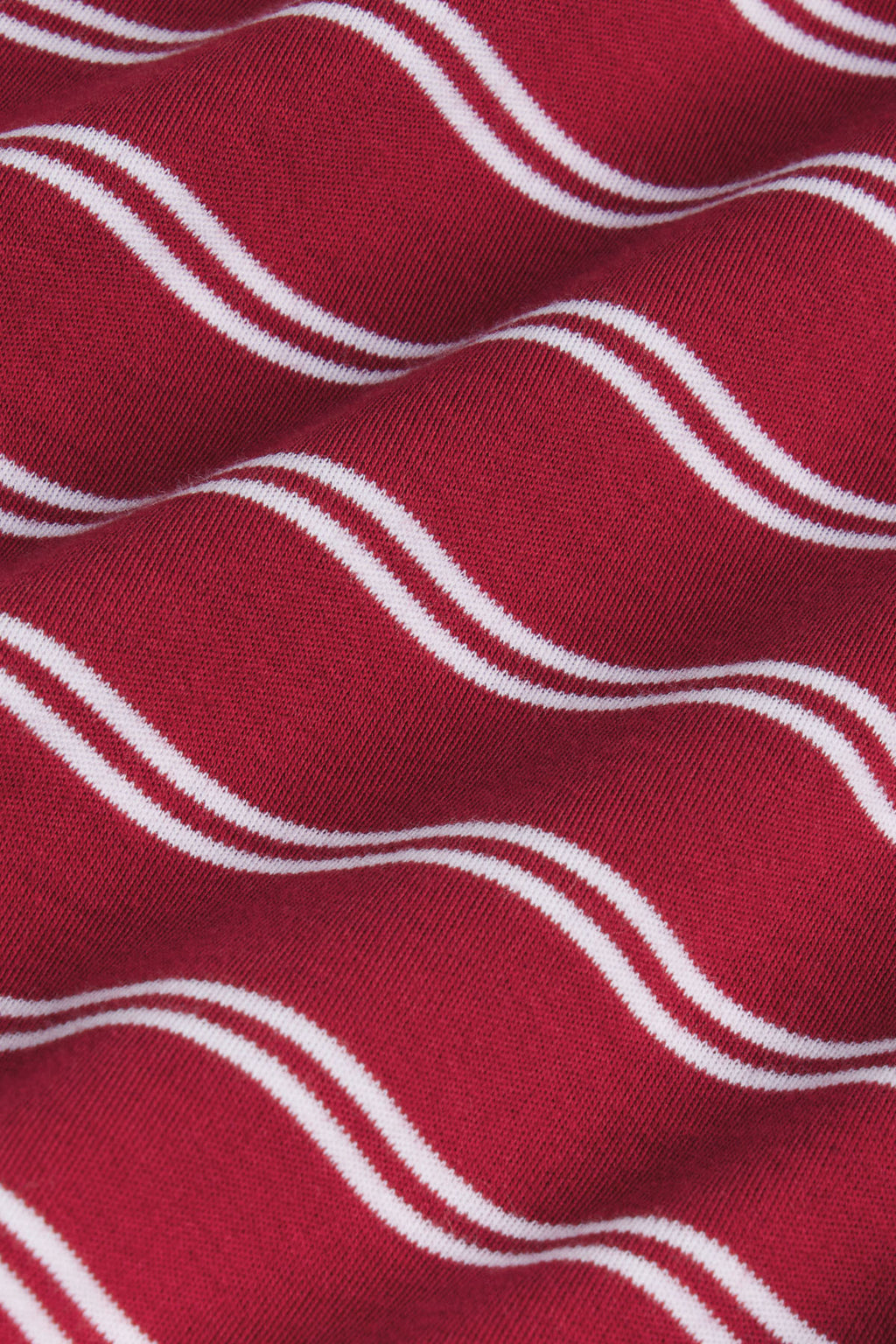 Garnet ribbed fabric with white wavy stripe pattern detail.