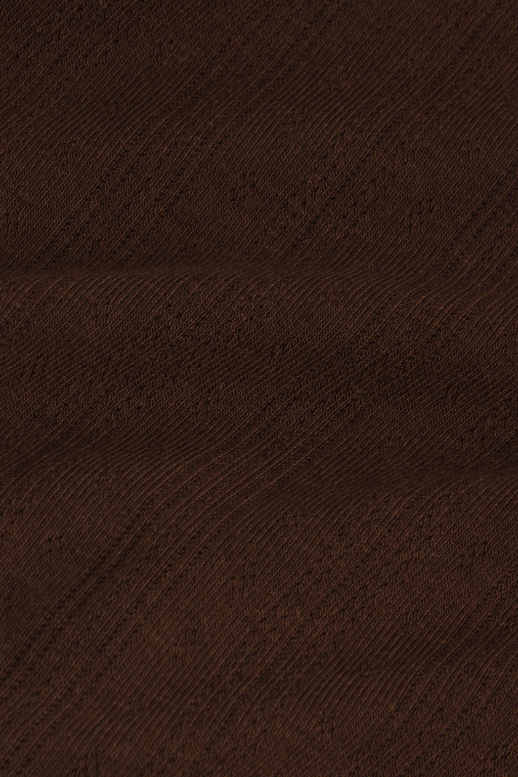 Cocoa brown pointelle knit fabric with diagonal textured weave pattern.