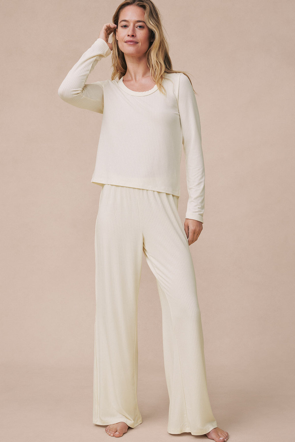 Woman wearing ivory ribbed long-sleeve top and matching wide-leg pants set.