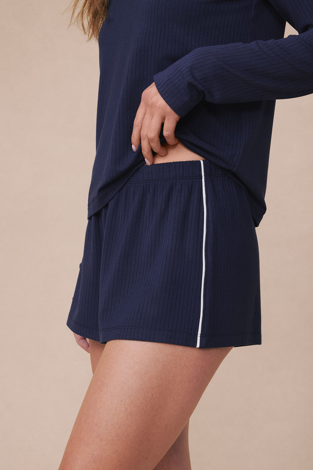 Navy ribbed long-sleeve top and shorts set with white stripe detail on shorts.
