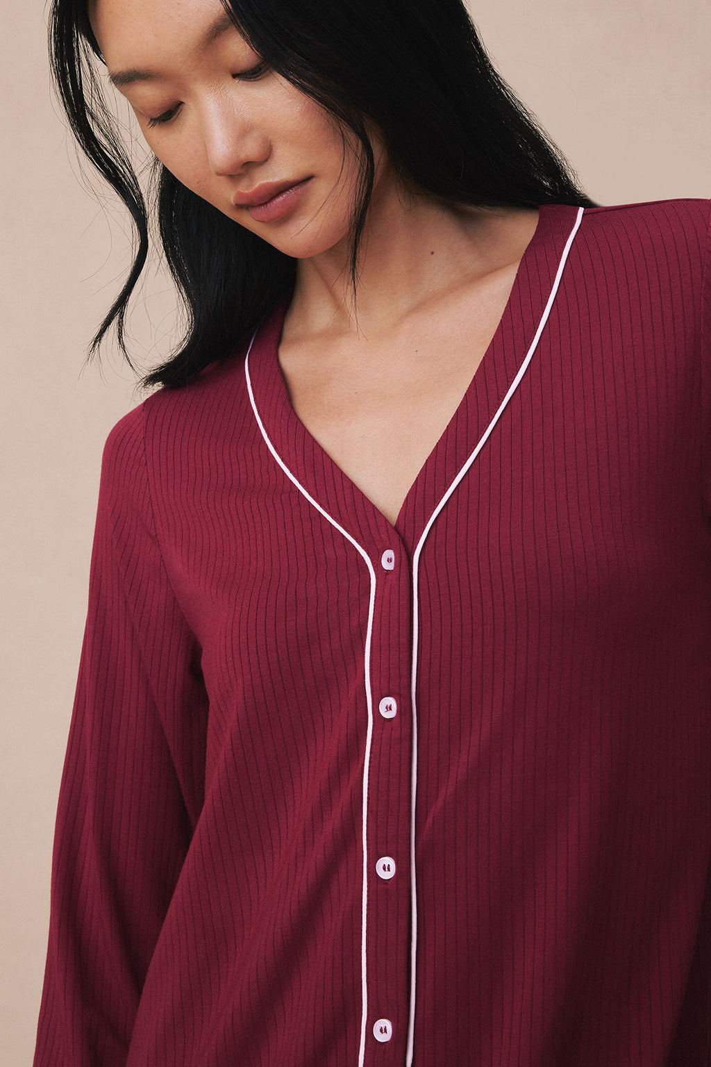 Burgundy long sleeve nightgown with white piping, V-neckline, and button front closure.