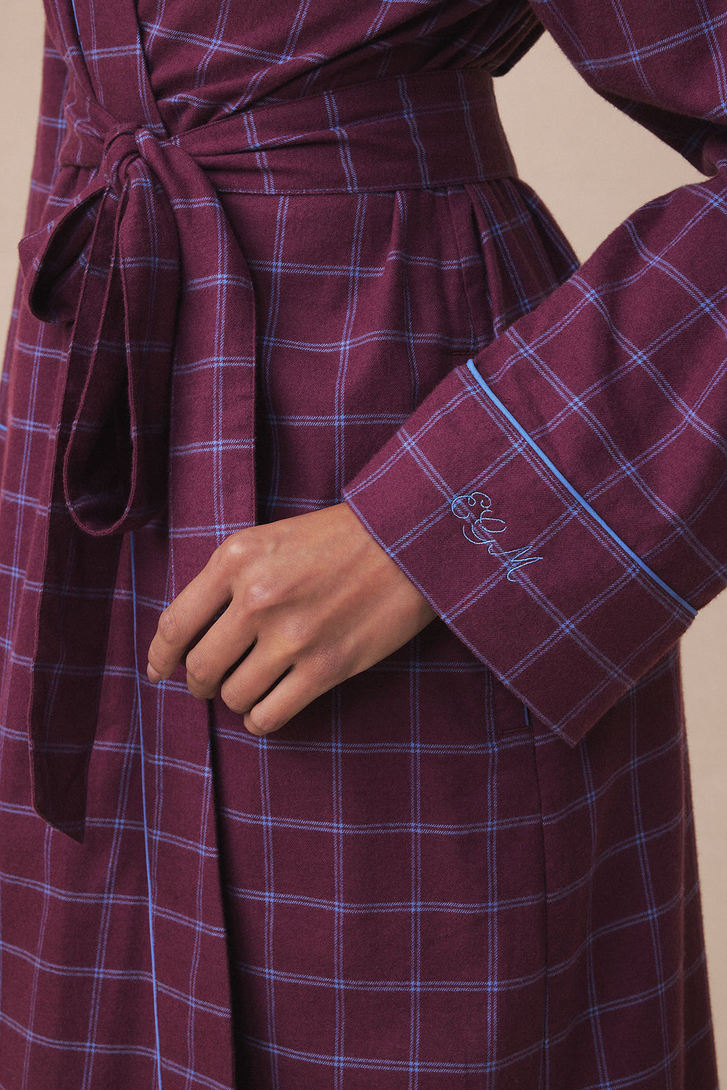Burgundy flannel robe with blue windowpane plaid pattern, wrap closure at waist, and embroidered detail on cuff.
