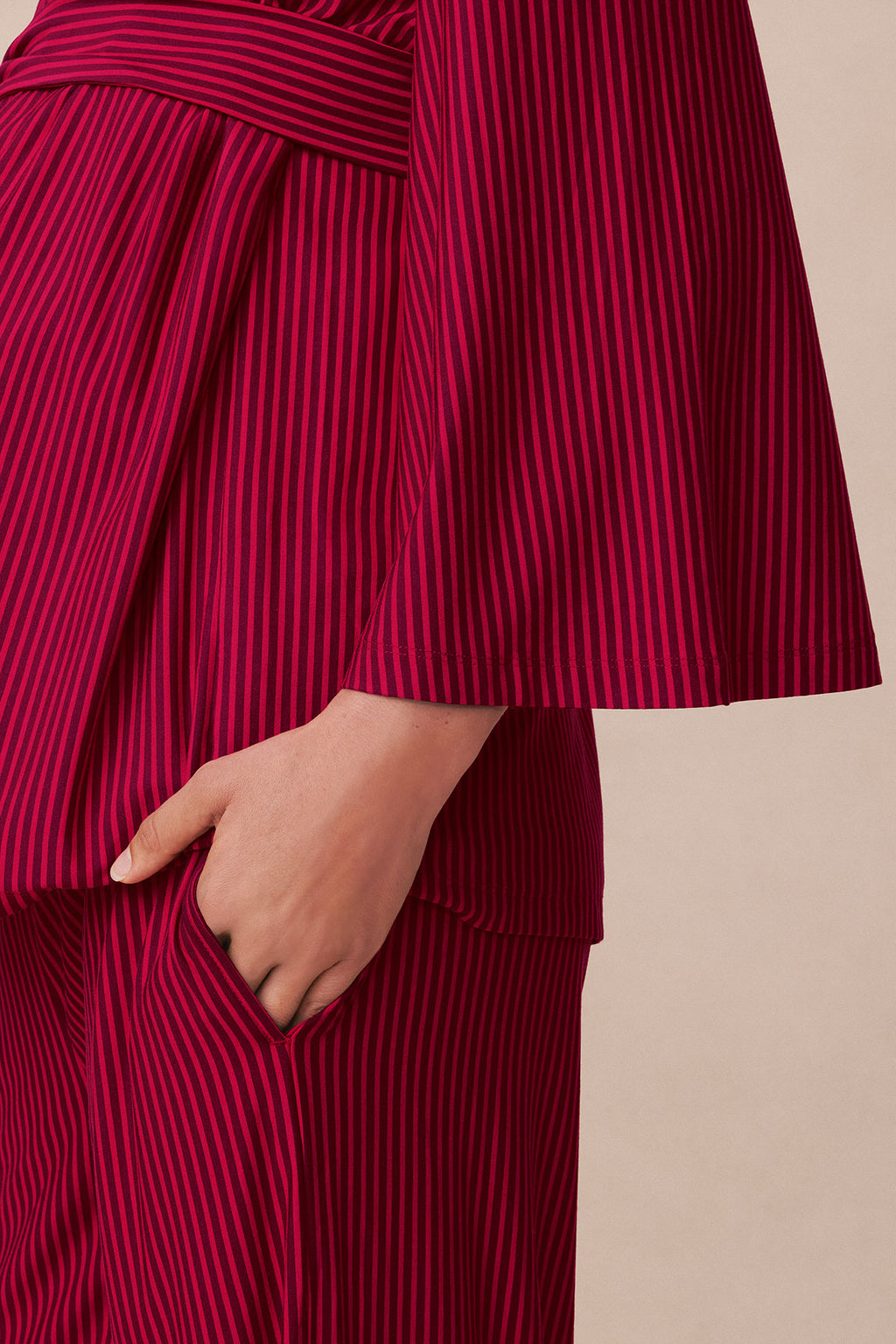 Burgundy and red vertical striped kimono robe with draped sleeves and side pocket, shown on model.