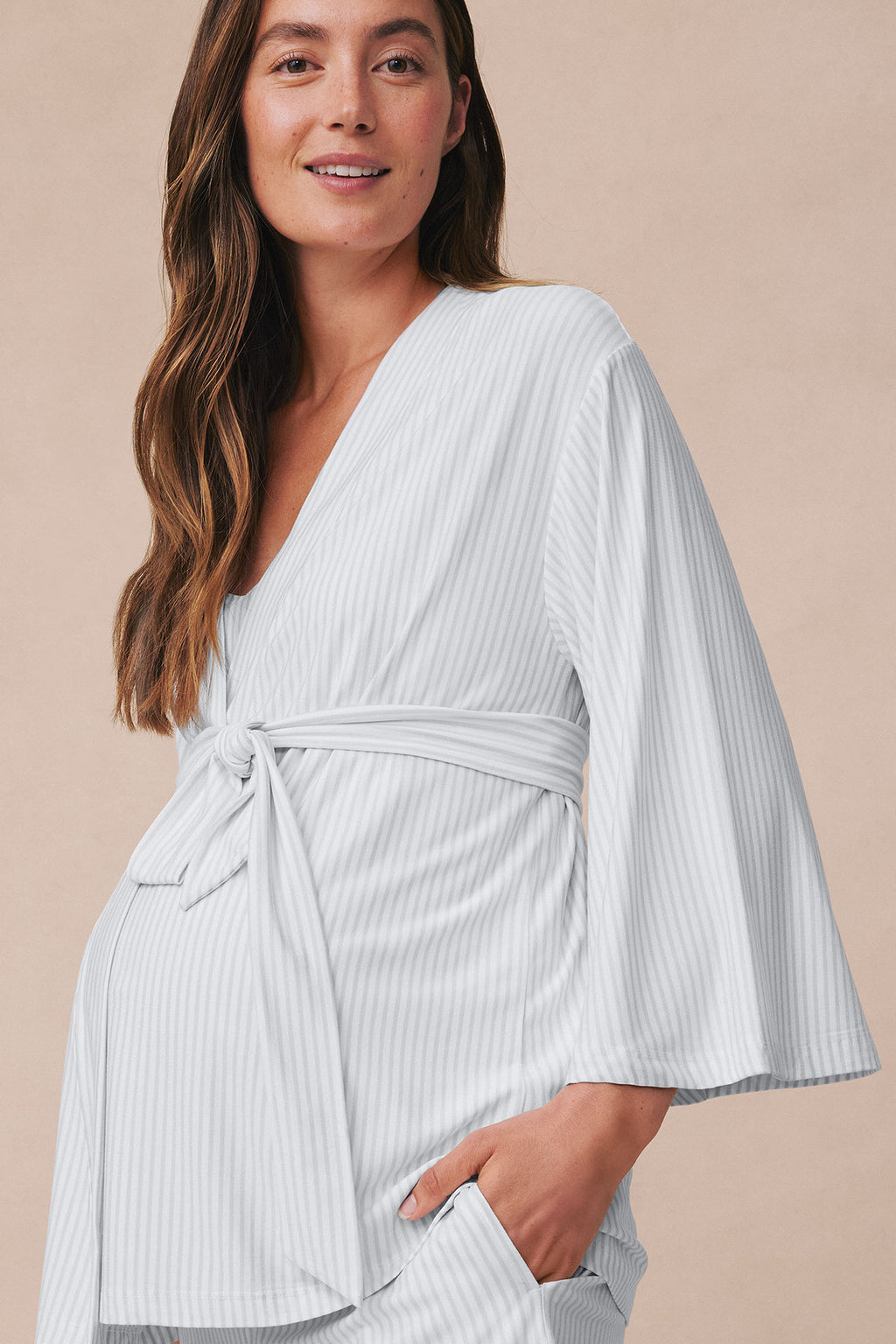 Pregnant woman wearing a light gray ribbed kimono robe with tie waist and matching shorts.