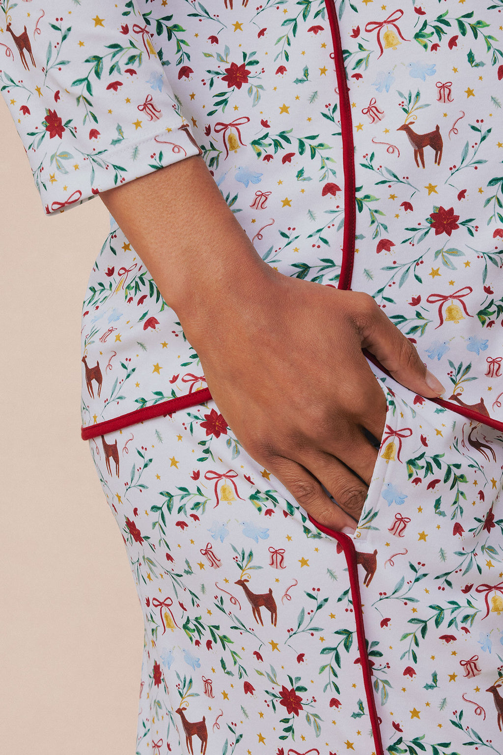 Light blue long-sleeve maternity pajama top with red piping, featuring holiday print with reindeer, poinsettias, stars, and g