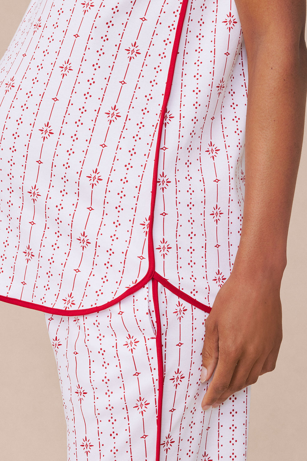 White Pima maternity set with red geometric and snowflake stripe pattern and red trim binding.