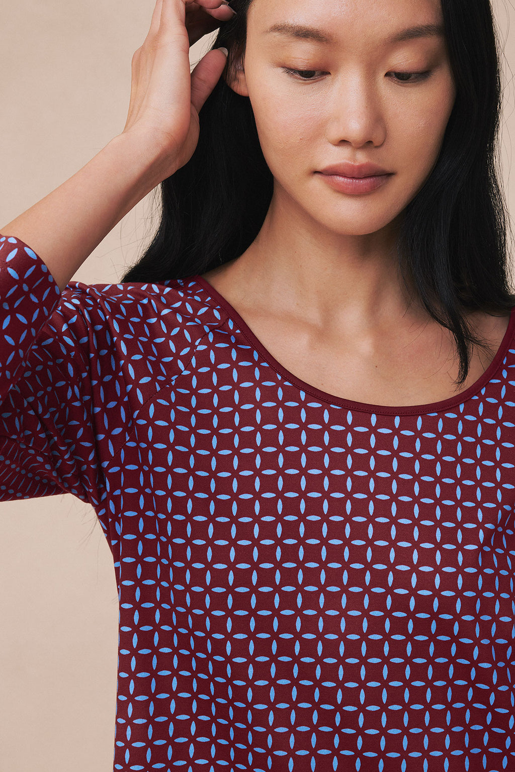 Burgundy nightgown with blue starburst pattern and long sleeves, shown on model.