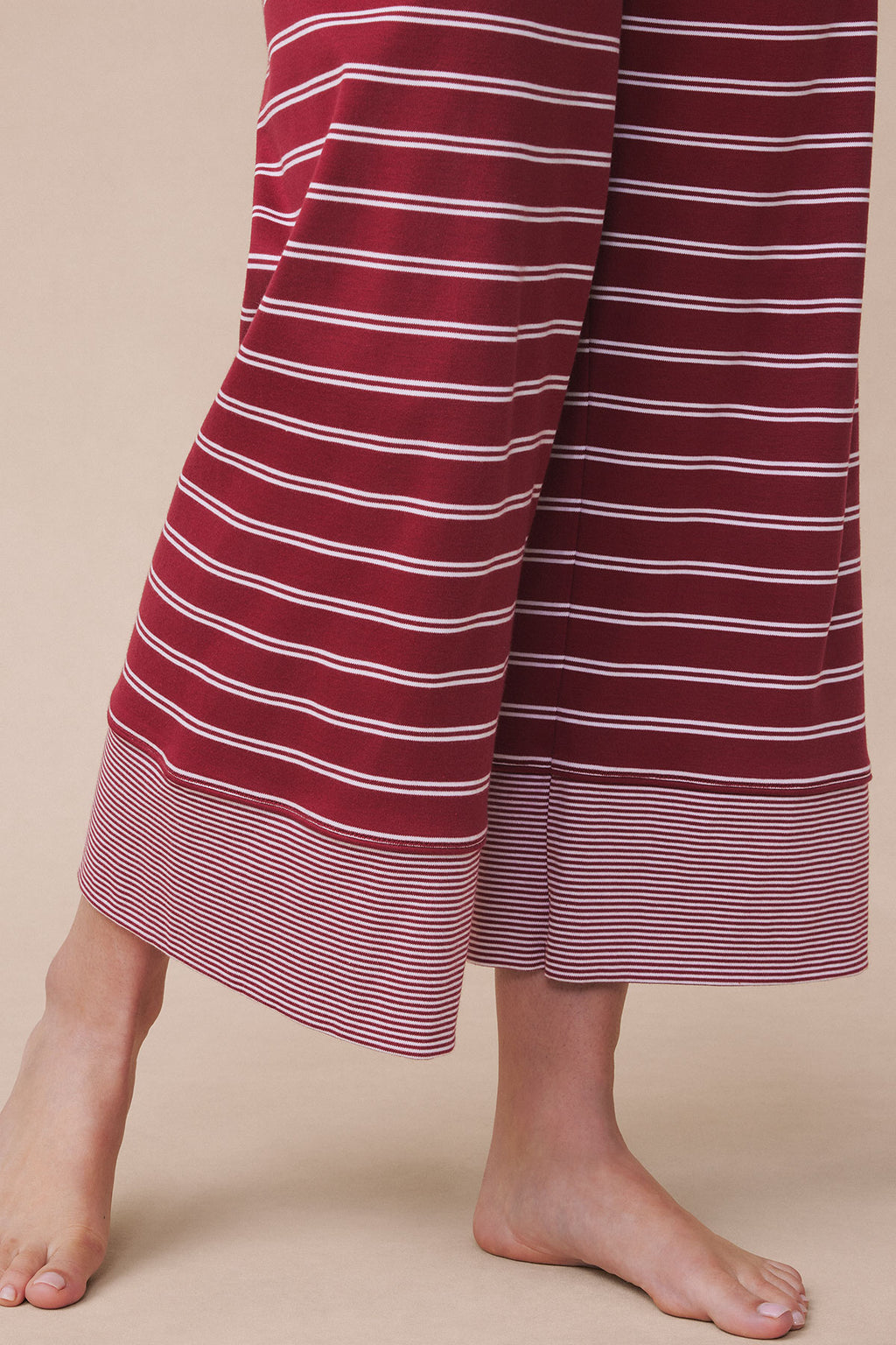 Garnet and white striped pajama pants with wide legs and horizontal stripes throughout.