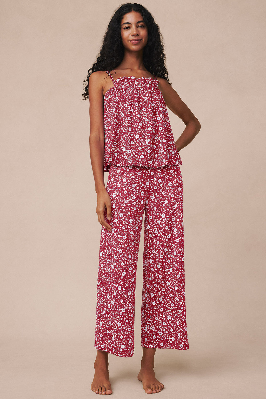 Sleeveless two-piece set in garnet with white floral print, featuring a draped top and wide-leg cropped pants with ruffle hem