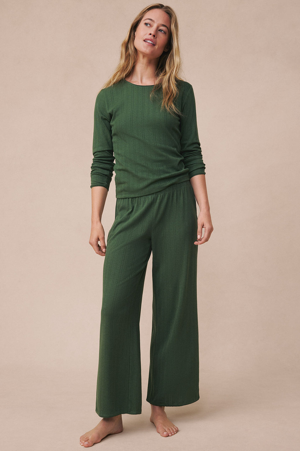 Woman wearing a rosemary green pointelle long-sleeve top and matching wide-leg pants.
