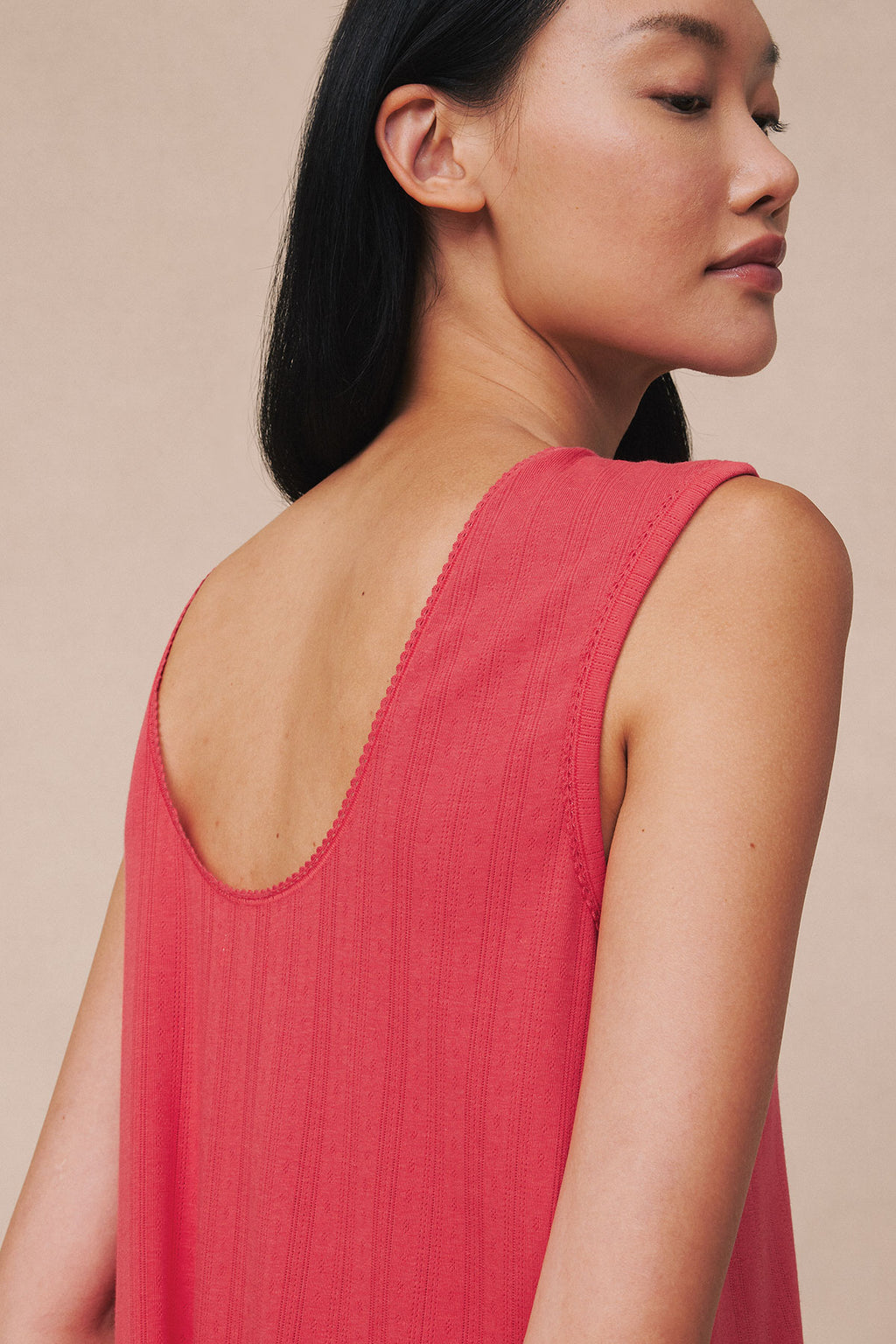 Cayenne red sleeveless tank gown with pointelle knit texture and low scoop back, shown on model from side profile.