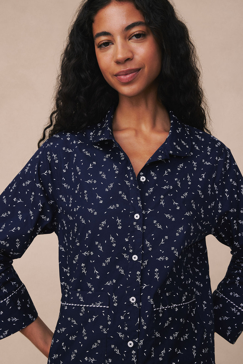Navy long-sleeve poplin pajama top with white floral print and piped trim details.
