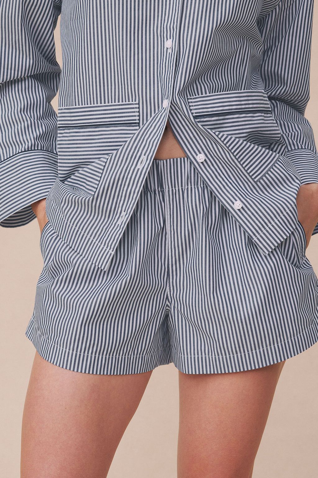 Navy and white striped poplin shirt with piped trim and matching shorts with horizontal stripe pattern.