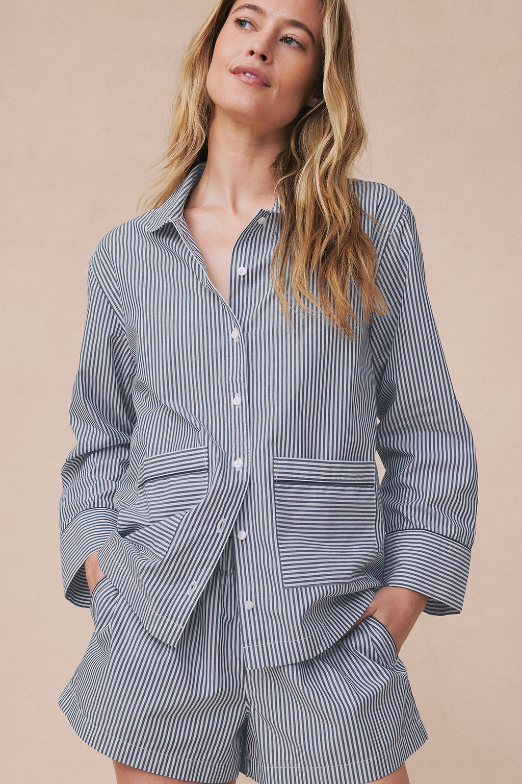 Navy and white striped button-front shirt with contrasting piped trim at cuffs and waist, paired with matching striped shorts