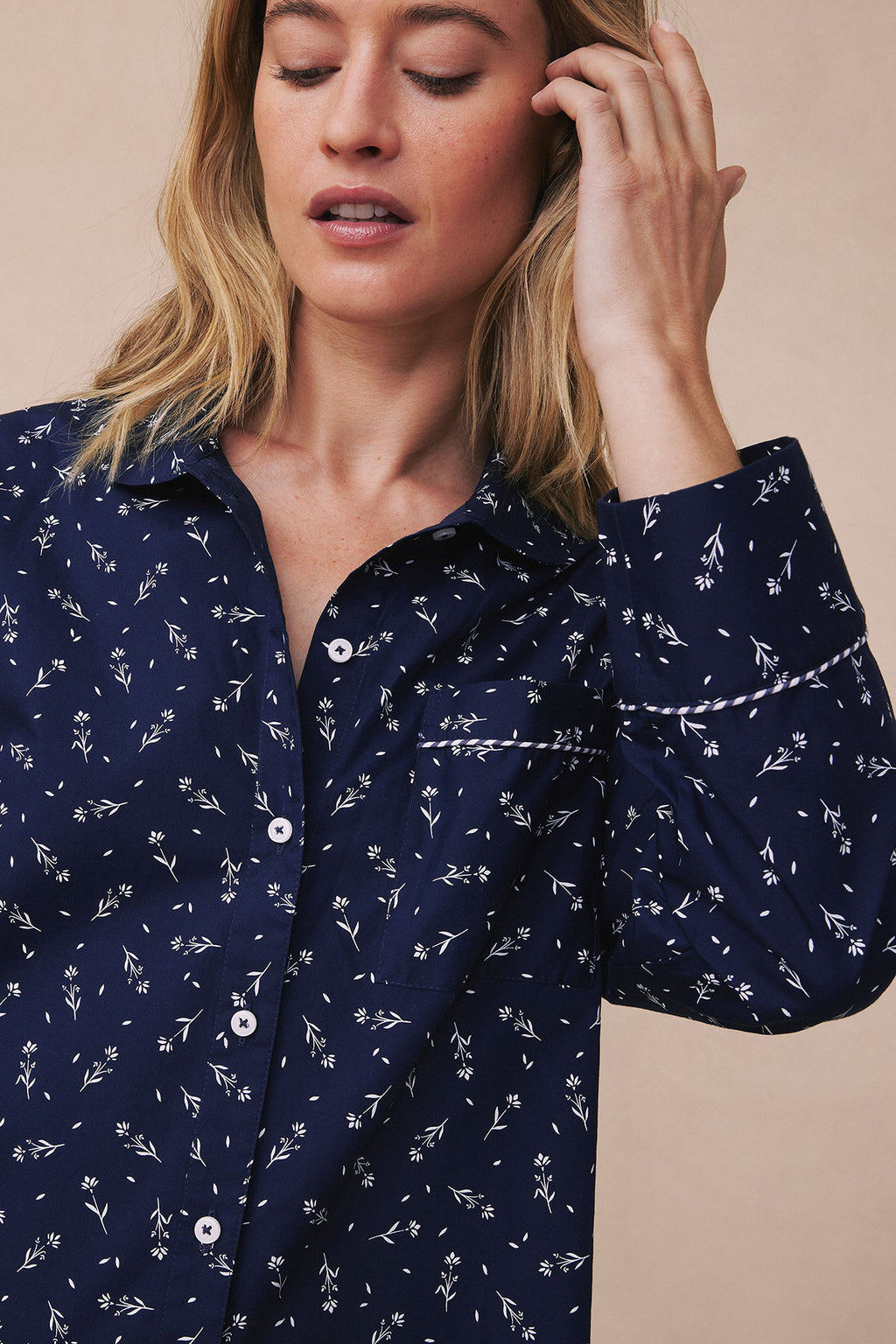 Navy nightgown with small floral print, button front, and piped trim at neckline and cuffs.