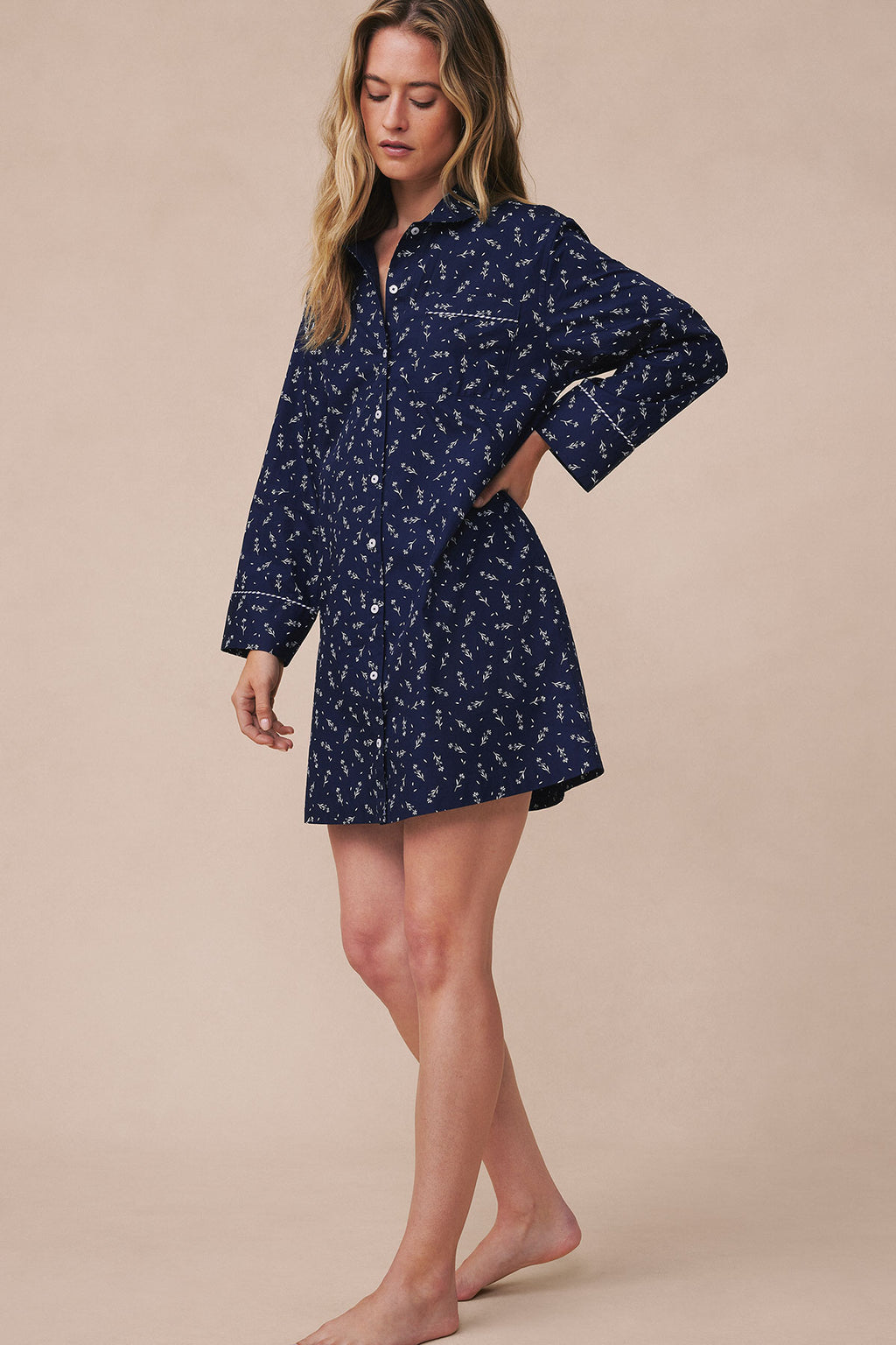 Navy poplin nightgown with white floral print, piped trim, button front, and three-quarter sleeves.