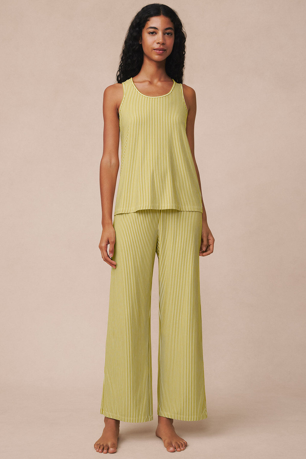 Model wearing yellow and white vertical striped sleeveless tank top and matching wide-leg pants.