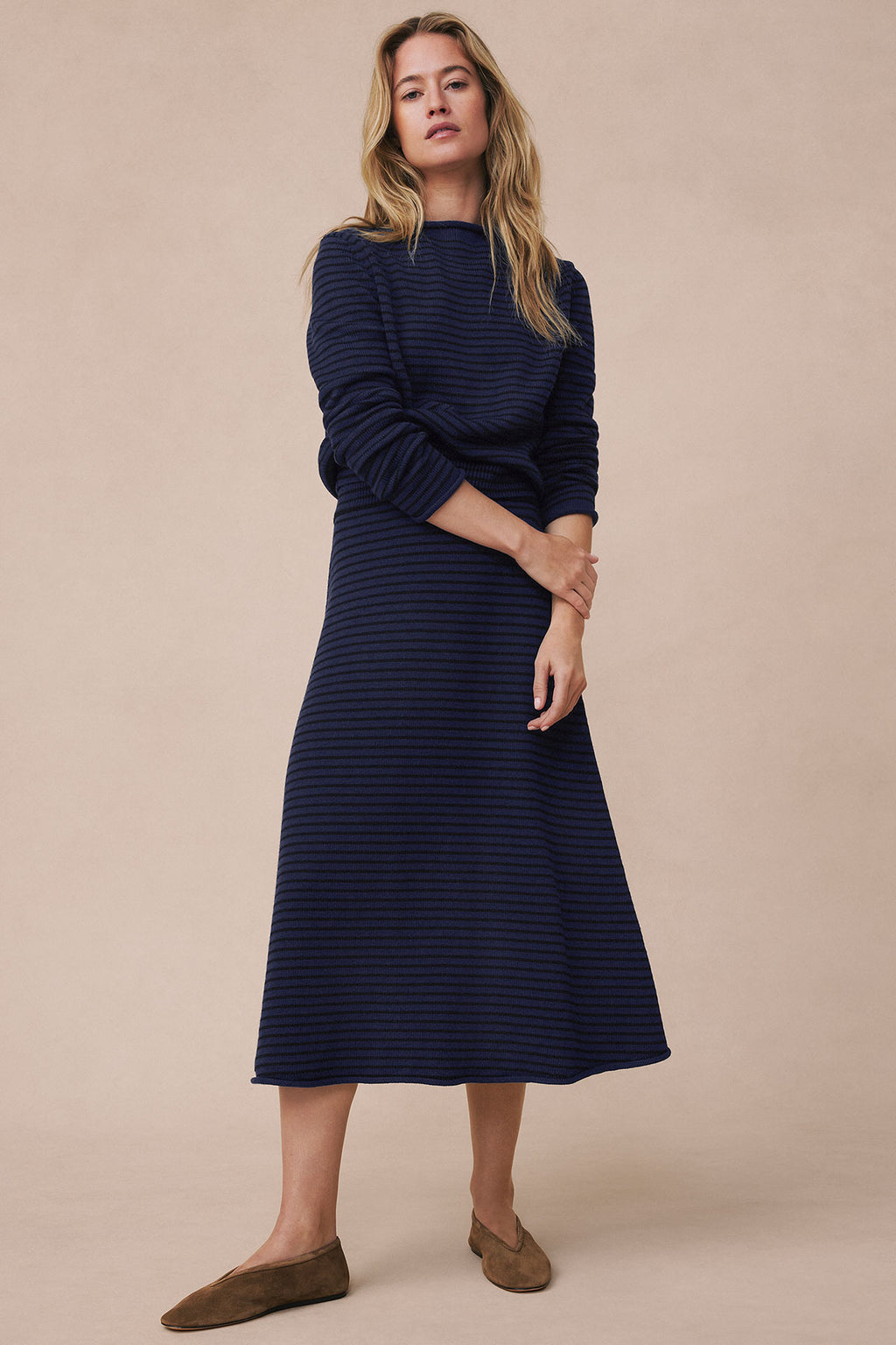 Navy striped sweater and midi skirt set with funnel neck and long sleeves on model.