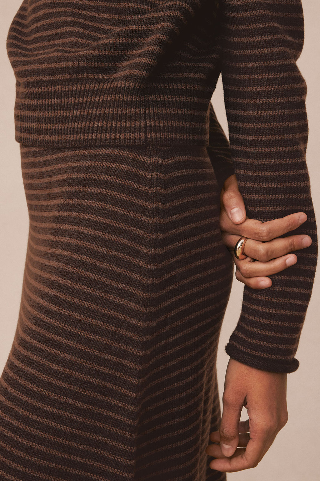 Brown and tan striped knit sweater dress with funnel neckline and midi length.
