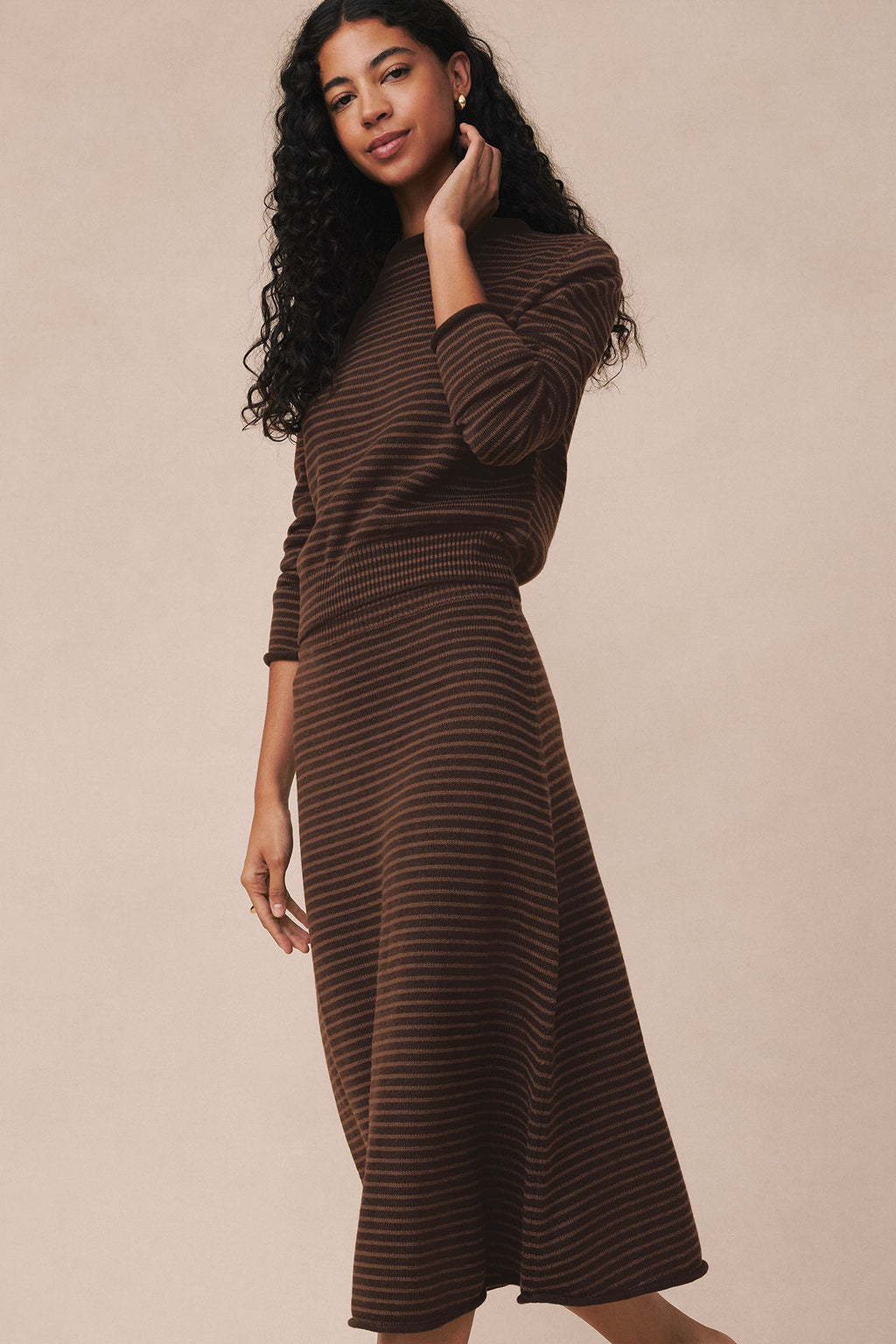 Brown and tan striped knit sweater and midi skirt set with funnel neckline and three-quarter sleeves.