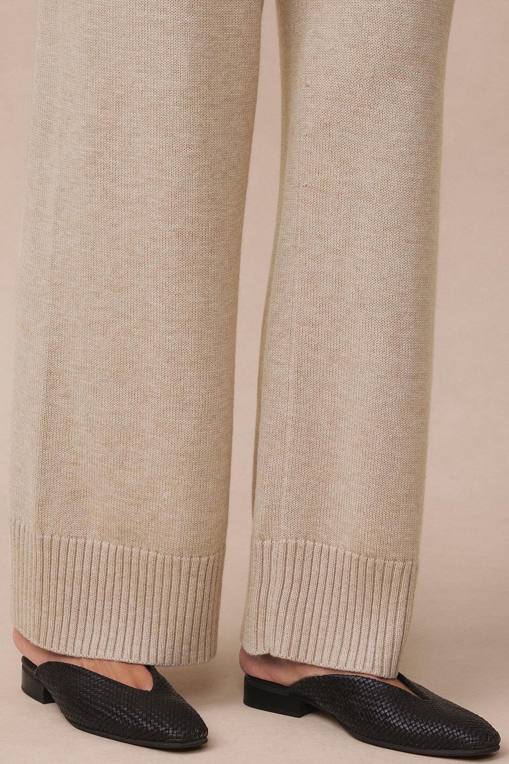 Ginger heather knit pants with ribbed cuffs, shown from waist down with black textured loafers.