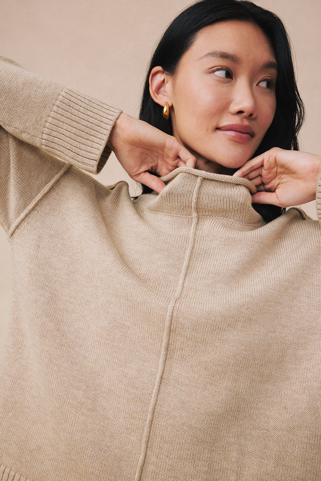 Ginger heather ribbed sweater with quarter-zip neckline and long sleeves on model.