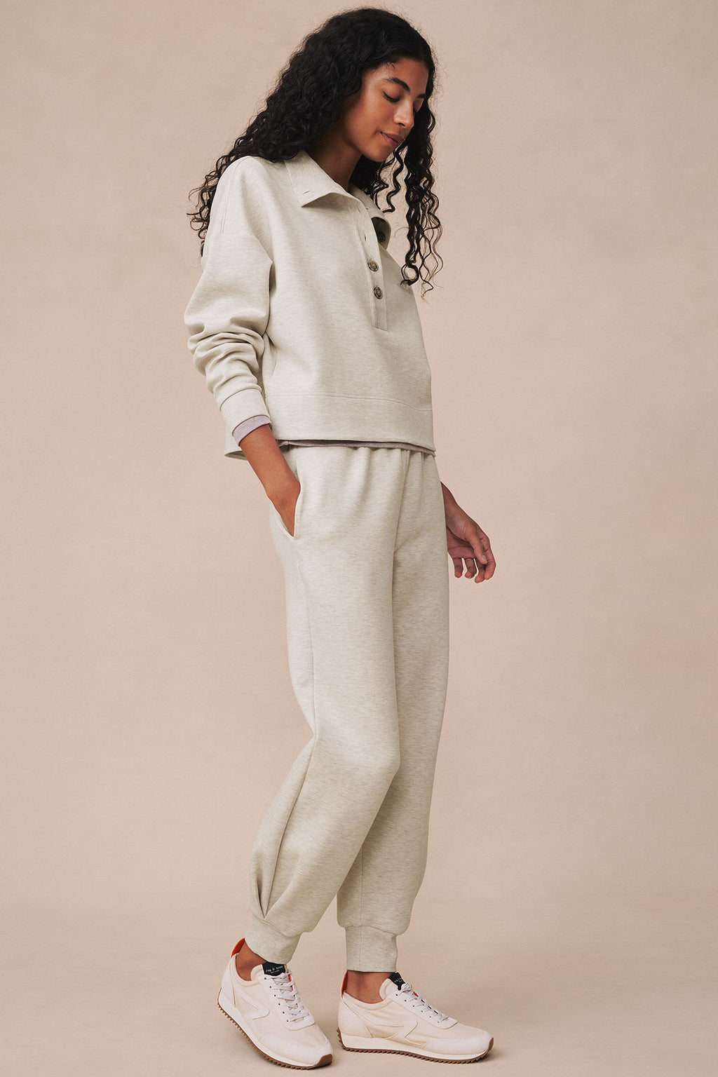Oat heather pullover with collar and matching jogger pants on model wearing white sneakers.