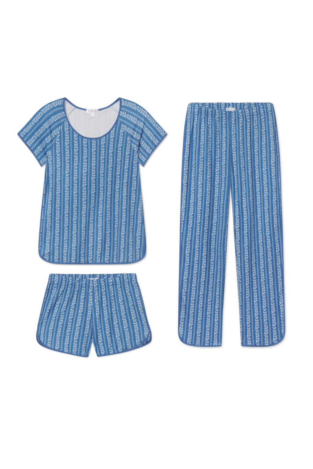 The Pima Bundle in Seaport Jasmine Vine features a blue pajama set in soft Pima cotton with a white striped vine print—includes a short-sleeve top, long pants, and shorts—all shown flat on a white background.