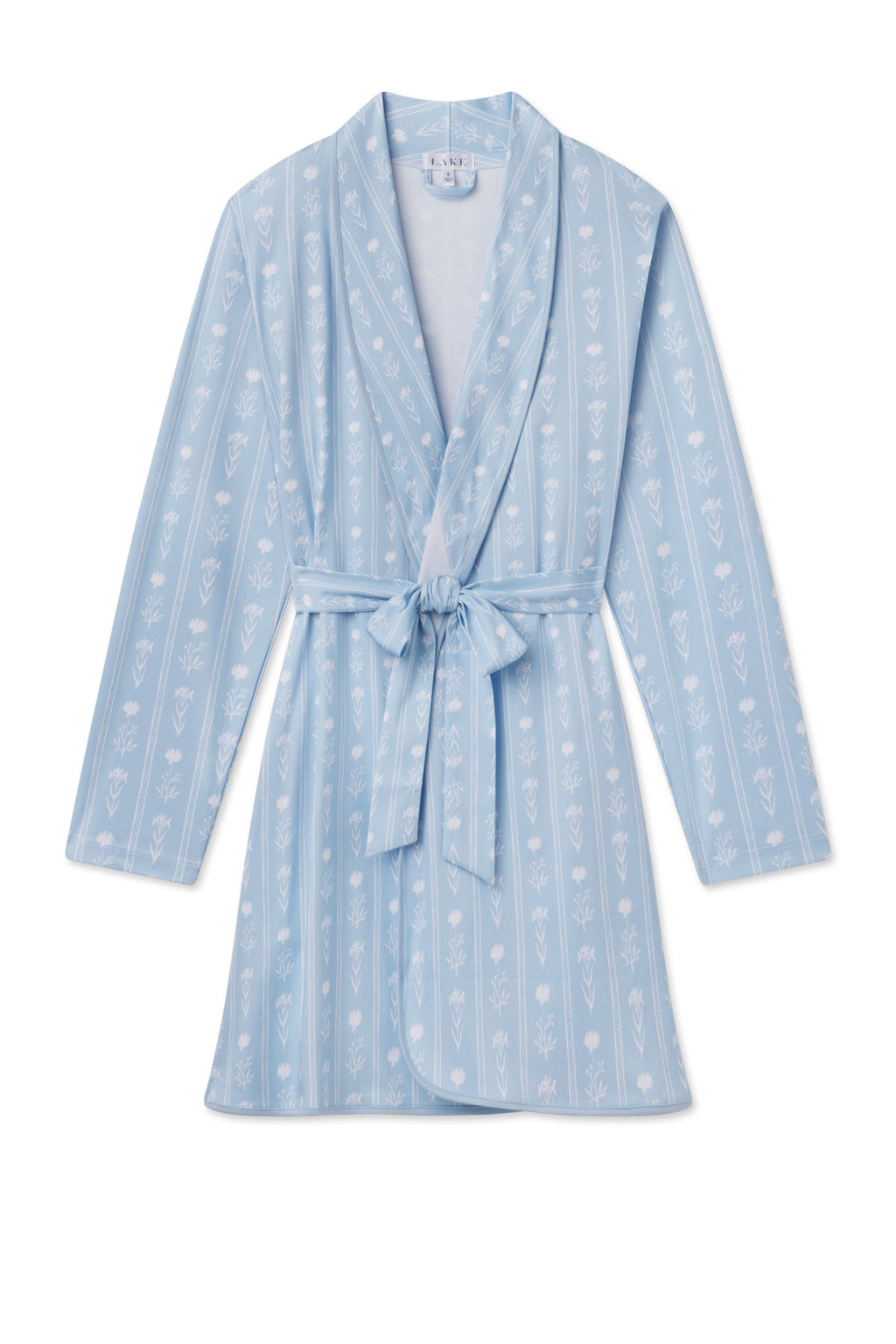 The Pima Short Robe in French Blue Watercolor Stems features light blue vertical stripes, long sleeves, a matching belt, and white floral accents. Made from 100% Pima cotton and shown flat on a white background.