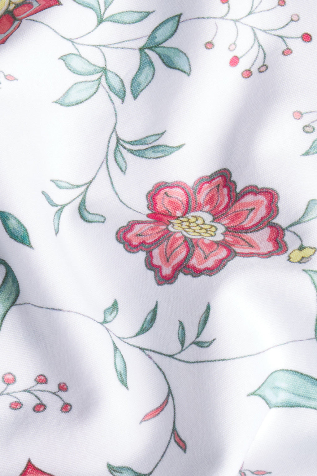 White Pima cotton fabric with pink flowers, green leaves, and vine pattern throughout.
