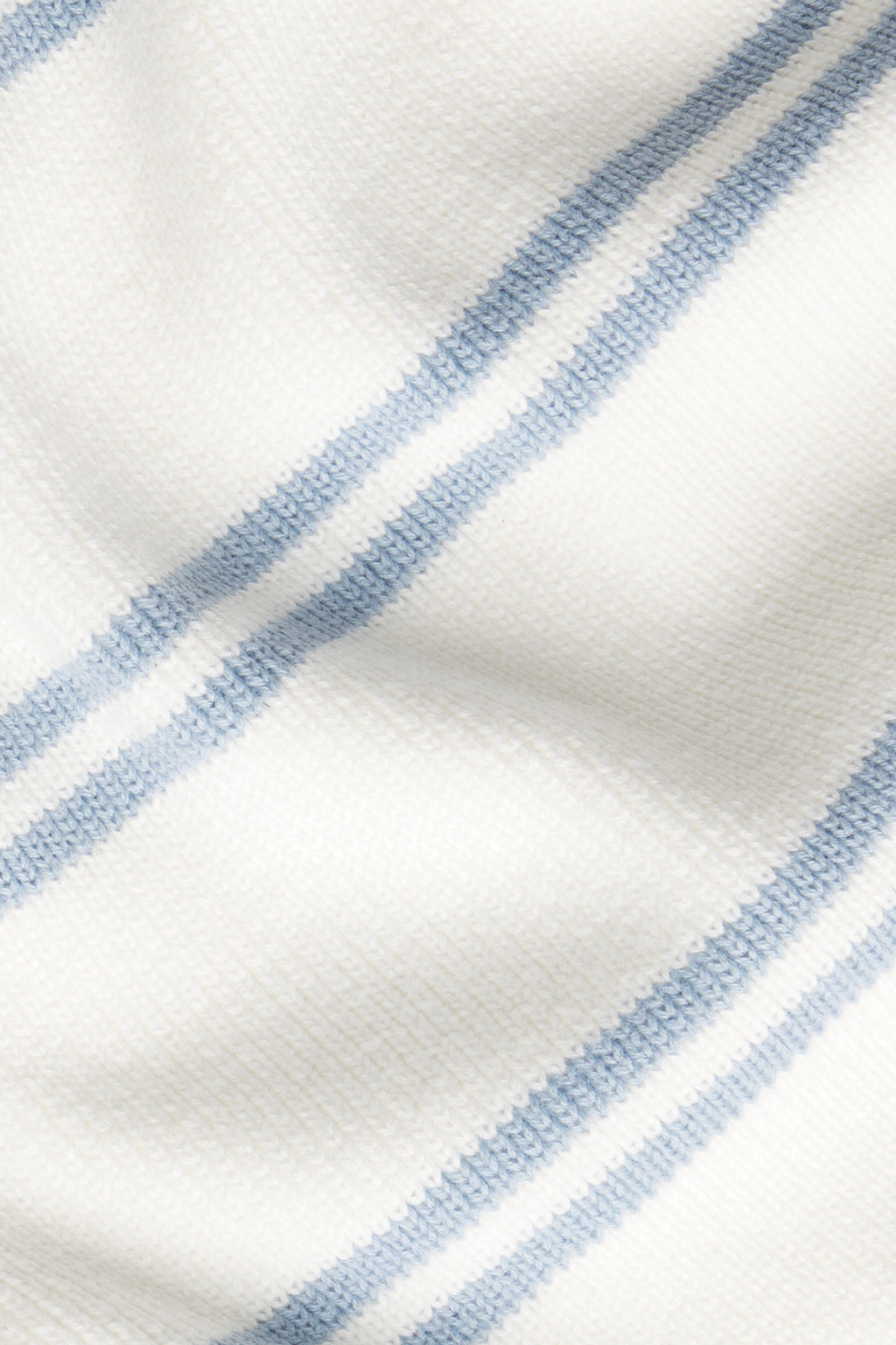 Close-up of the Nora Cotton Cardigan in Ivory Dusty Blue Stripe, showcasing its soft, textured 100% cotton fabric with two parallel light blue stripes across an ivory surface.