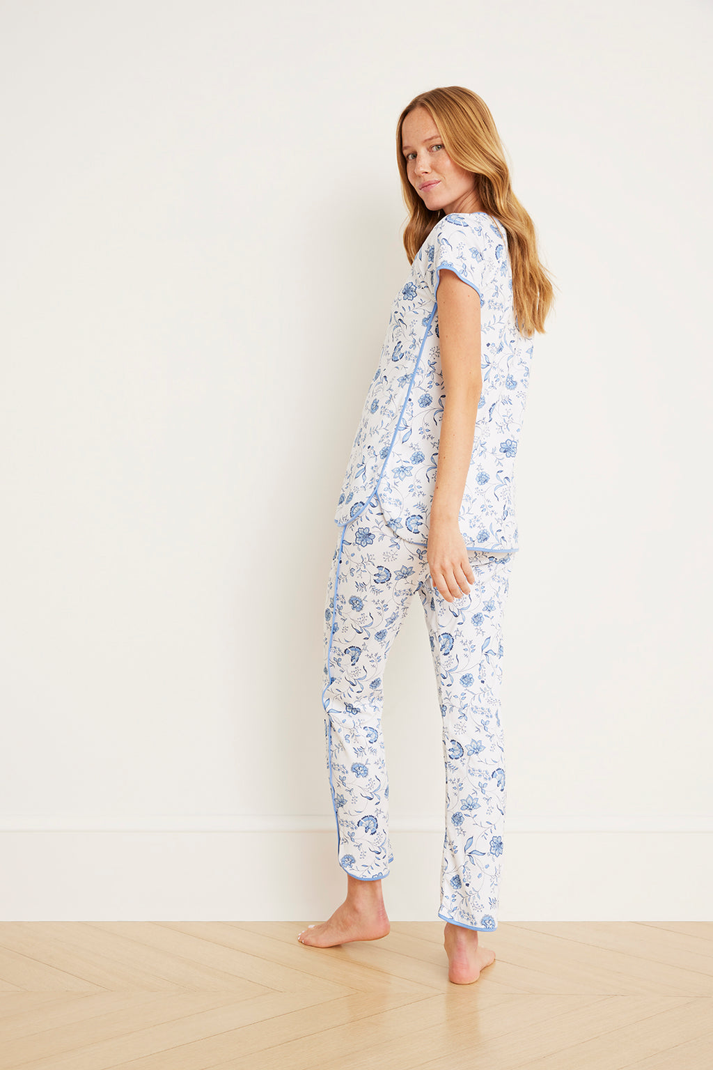 Maternity pajama set with blue floral vine pattern on white, short-sleeve top and full-length pants.
