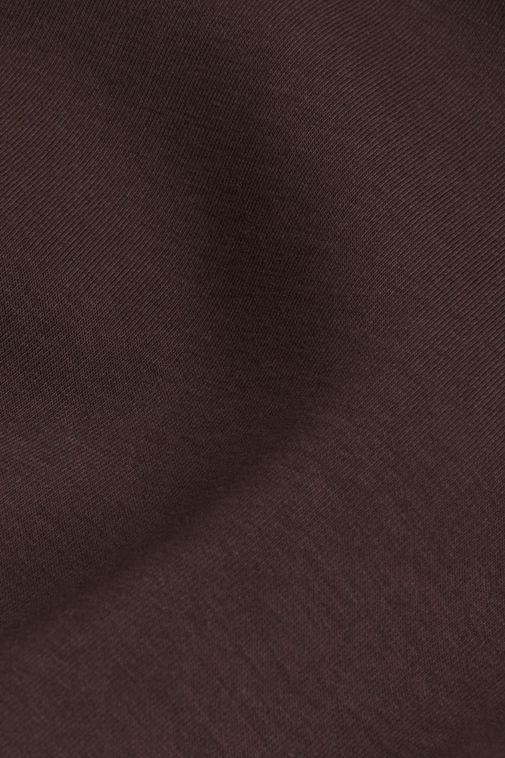 Dark brown textured fabric with diagonal ribbed weave pattern.