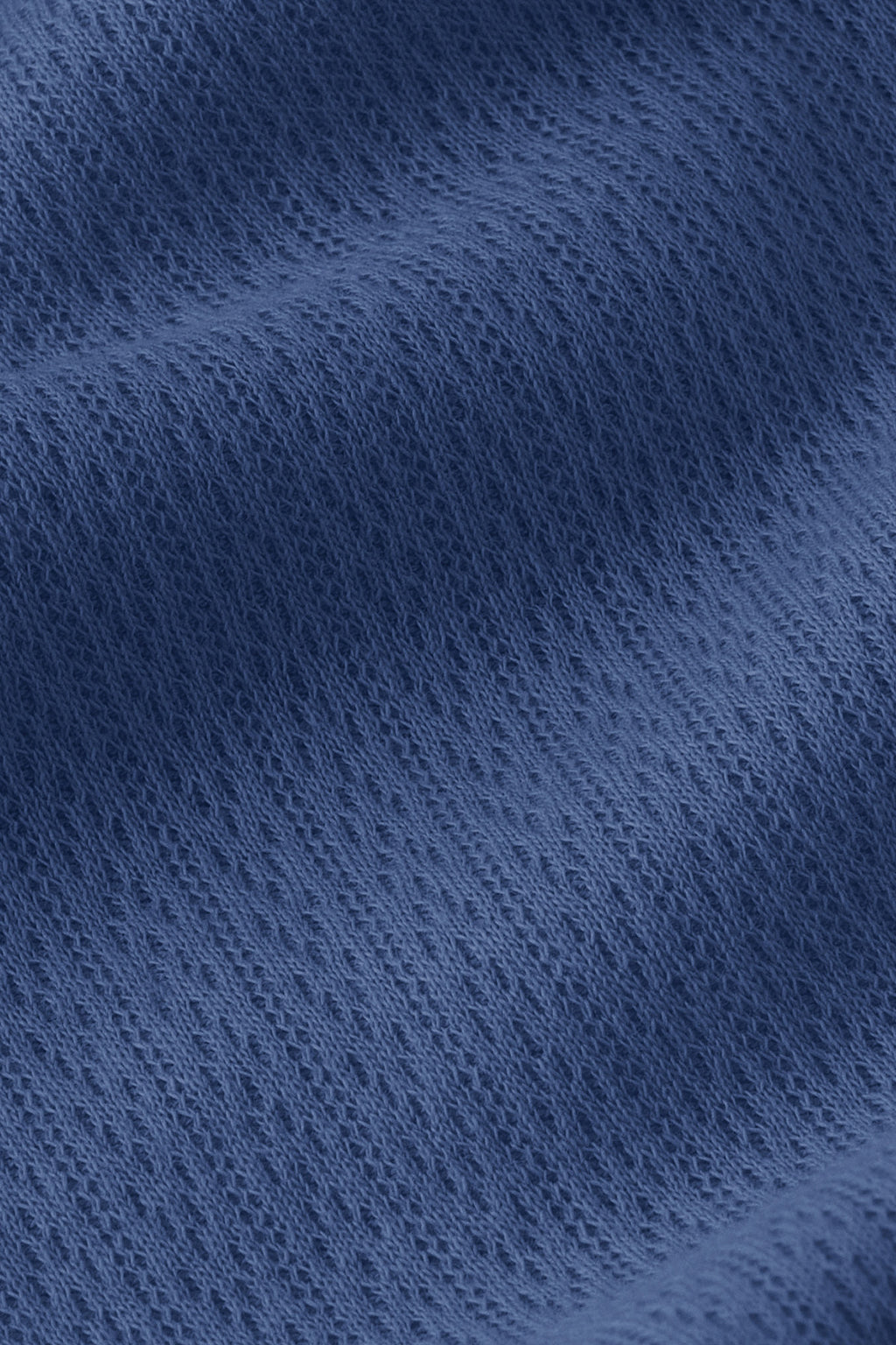 Close-up of the Pointelle Pajama Pants Set in Navy, showcasing soft, textured blue knit fabric with visible diagonal weave patterns and gentle folds for added depth.