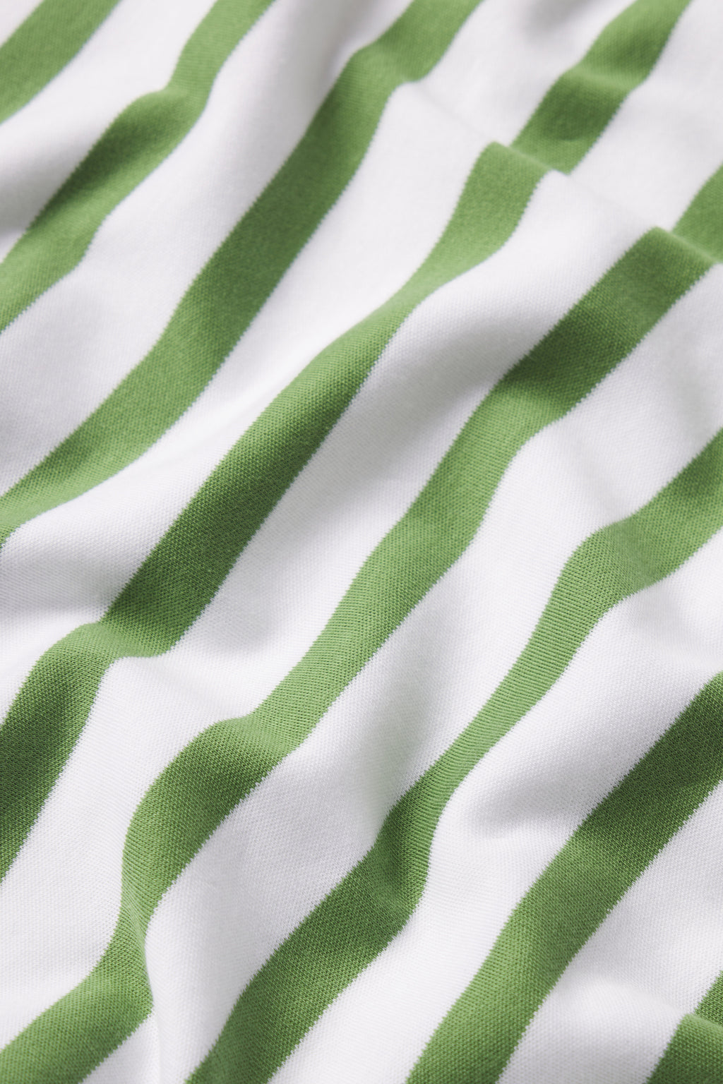 Close-up of the Pima Shorts Set in Willow Bough Stripe, featuring moss green pajamas with white diagonal stripes and visible texture.