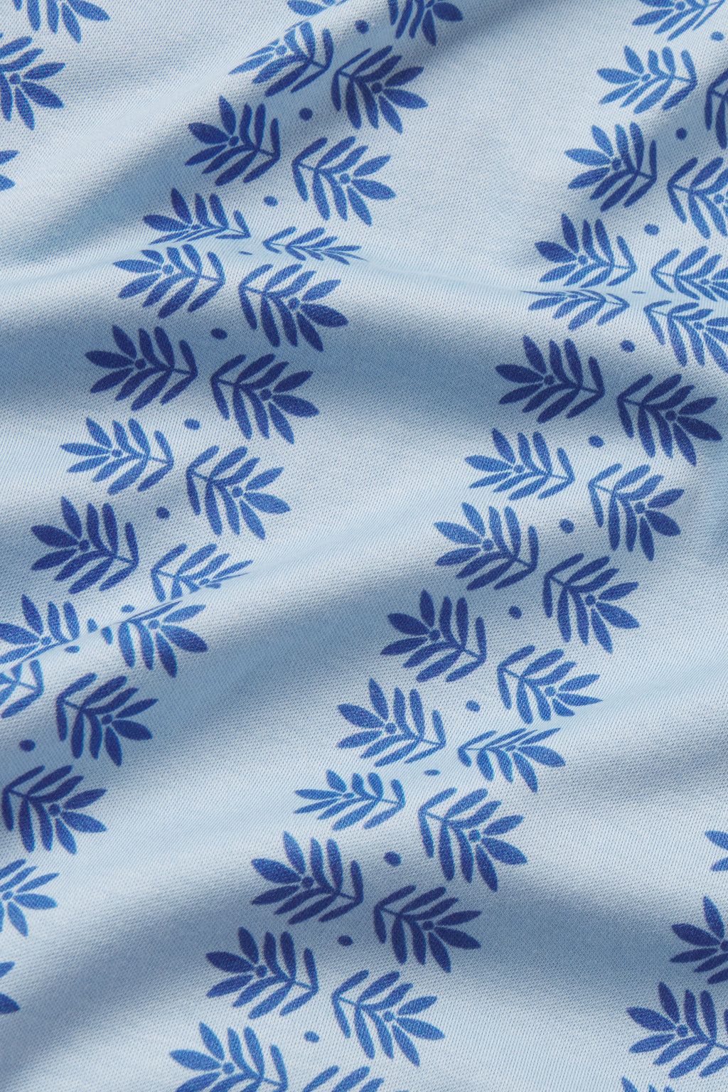 The Pima Ruffle Pants Set in French Blue Trellis features light blue fabric with a repeating dark blue circular leaf pattern, gentle folds, and the soft texture of premium Pima cotton.