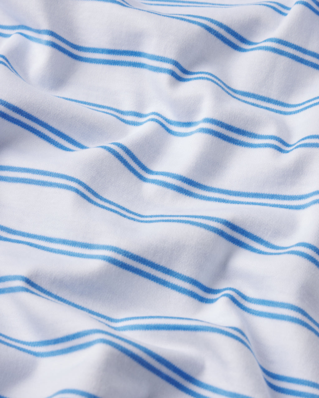 The Pima Ruffle Pants Set in Regatta Tidal Stripe features white Pima cotton fabric with light and dark blue horizontal stripes, displayed here with soft folds.