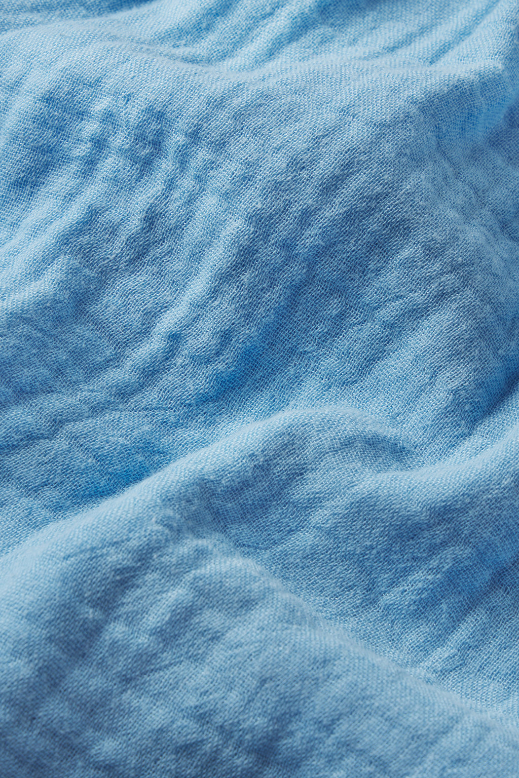 Close-up of the Hamptons Shorts Set in Serene Blue, featuring soft gauze fabric with delicate folds and visible fibers—a wavy texture ideal for hot sleepers.